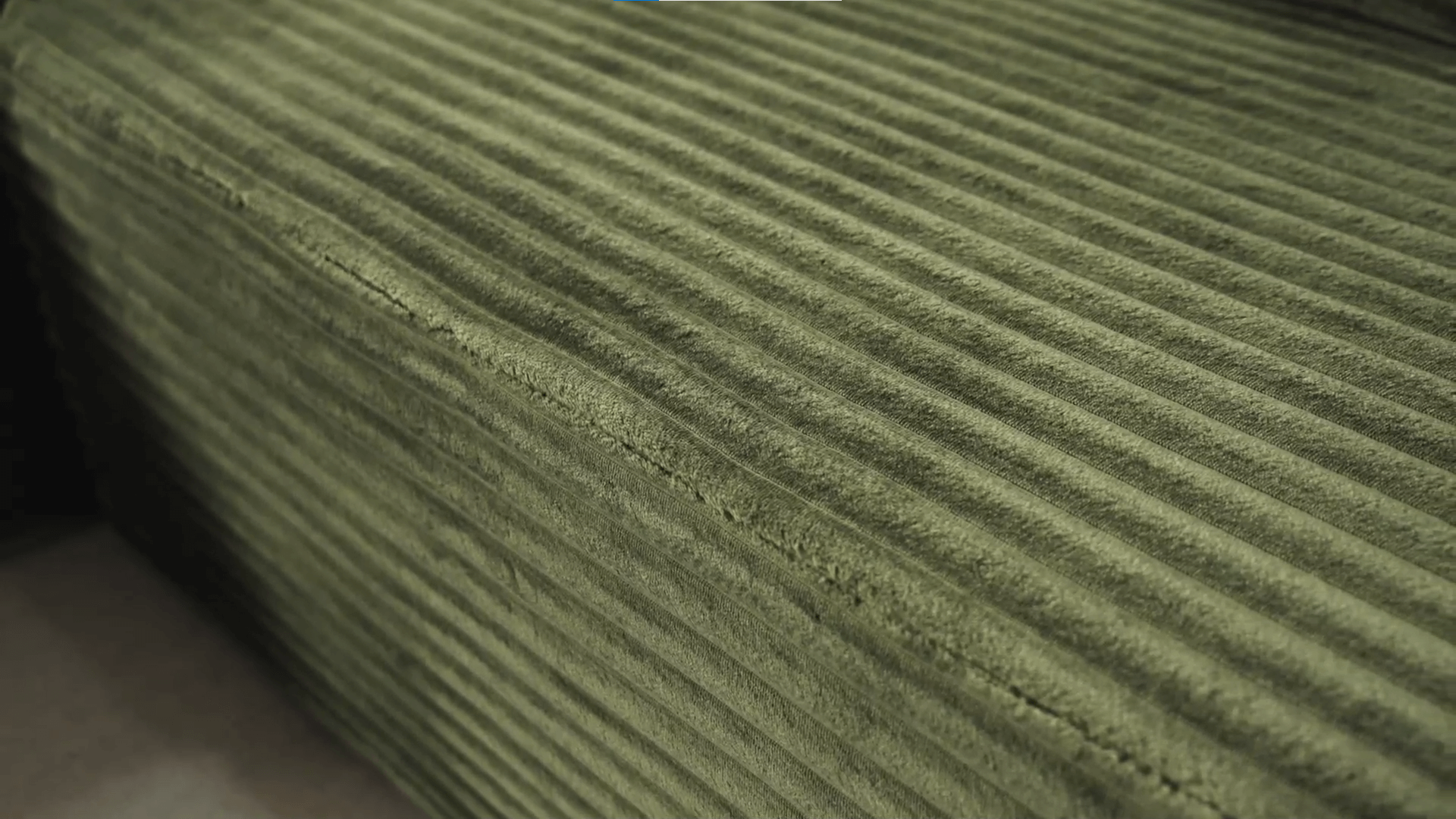 A green sectional sofa sold by WorkZen Interiors