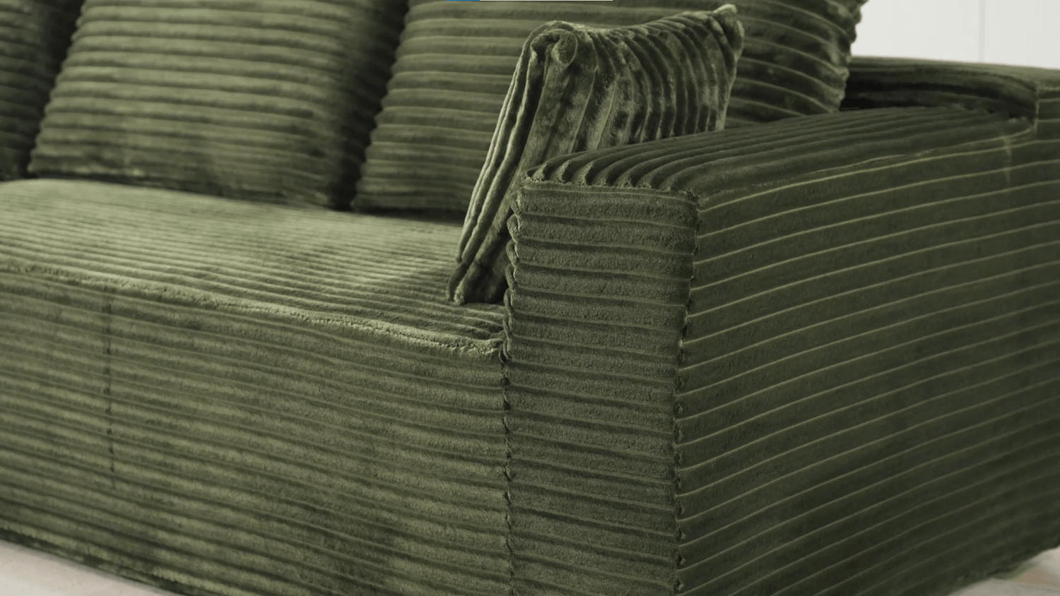 A green sectional sofa sold by WorkZen Interiors