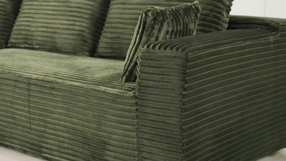 A green sectional sofa sold by WorkZen Interiors
