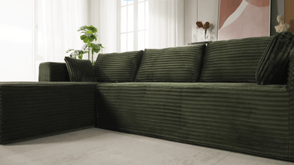 A green sectional sofa sold by WorkZen Interiors