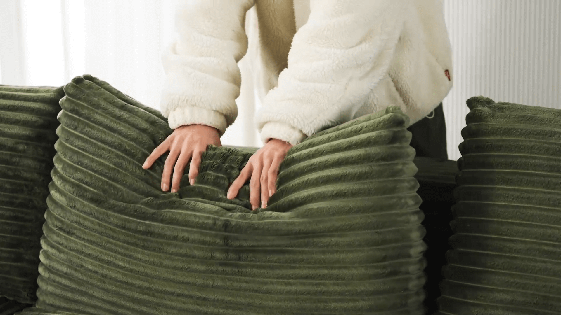 A green sectional sofa sold by WorkZen Interiors