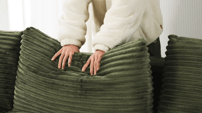 A green sectional sofa sold by WorkZen Interiors